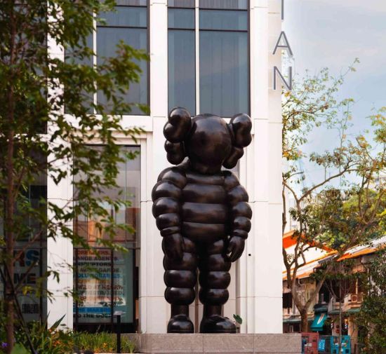 Image of a large, black KAWS statue outside Mondrian Singapore Duxton hotel