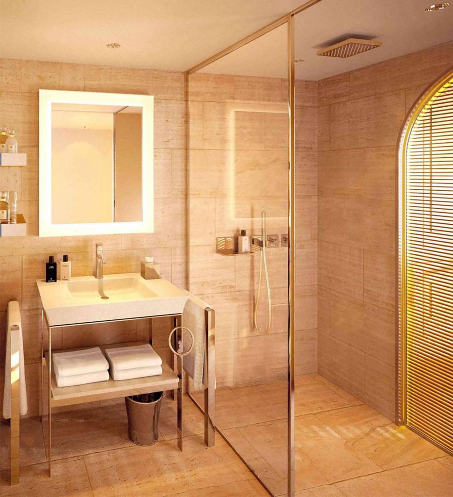 A modern bathroom featuring a sink, mirror, and shower with glass door.