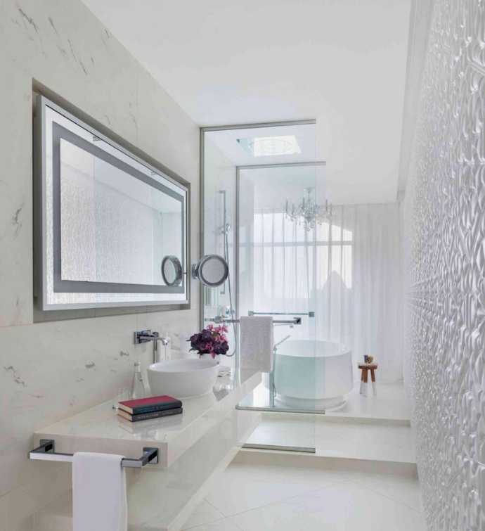 Salle de bain entièrement blanche avec vasque, miroirs, baignoire et douche 