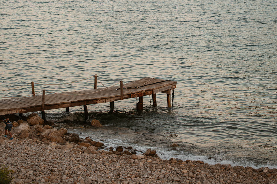 Wooden dock over the water at Cala Llonga Bay in Ibiza.