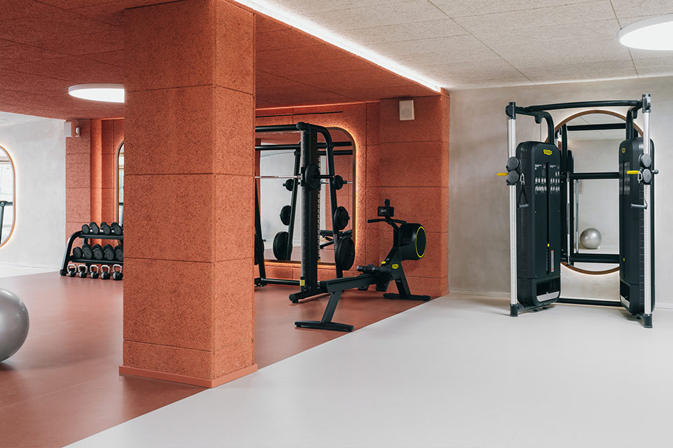 Modern fitness center with state of the art weight lifting equipment and lots of mirrors.