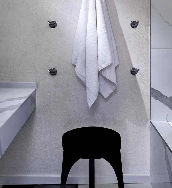 Towel hanging above a black stool