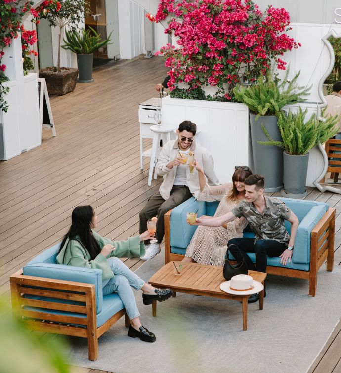 Three guests sitting and enjoying cocktails at Skybar Los Angeles