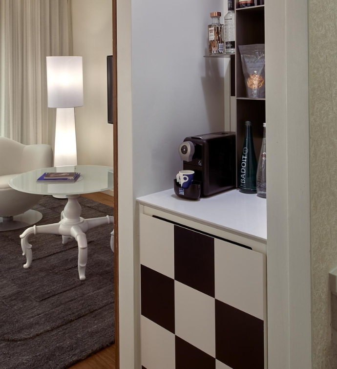 Black and white mini bar with a coffee machine on top