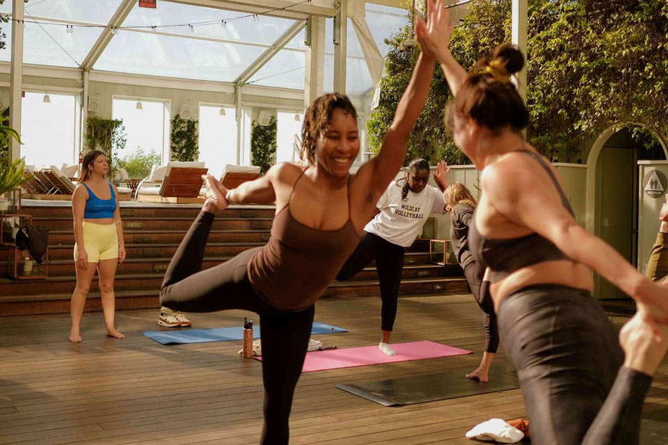 Women doing yoga on the rooftop of Mondrian Los Angeles.