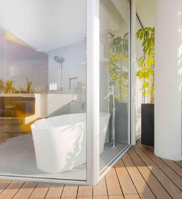 a view of the soaking tub from the terrace, with large glass windows