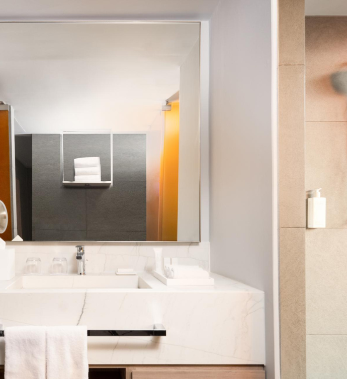 a sleek bathroom with a vanity area and shower