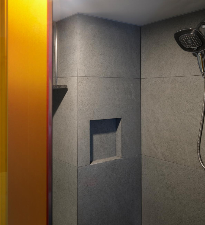 a modern shower with orange glass