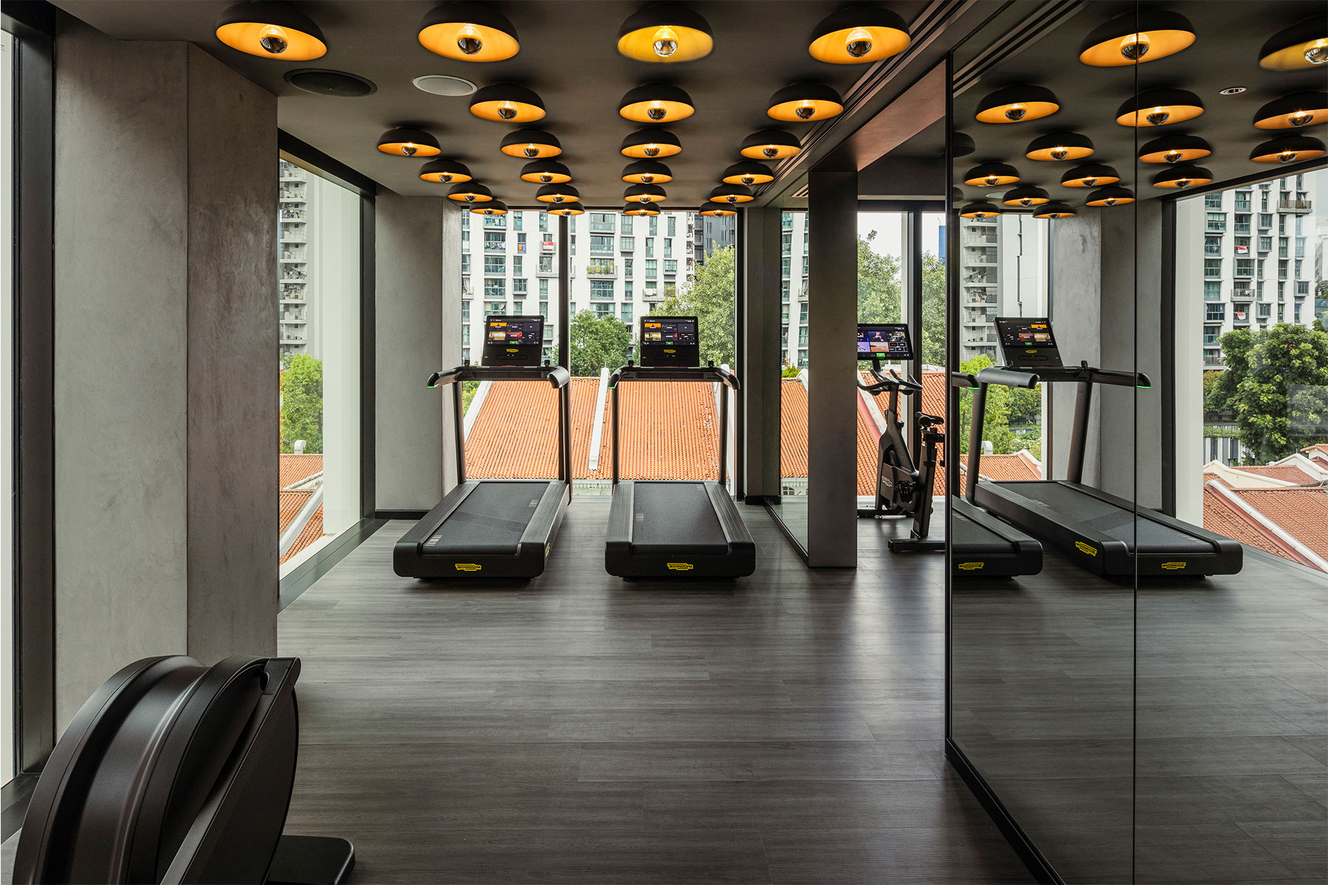 Fitness center with two treadmills with views of the city of Singapore.