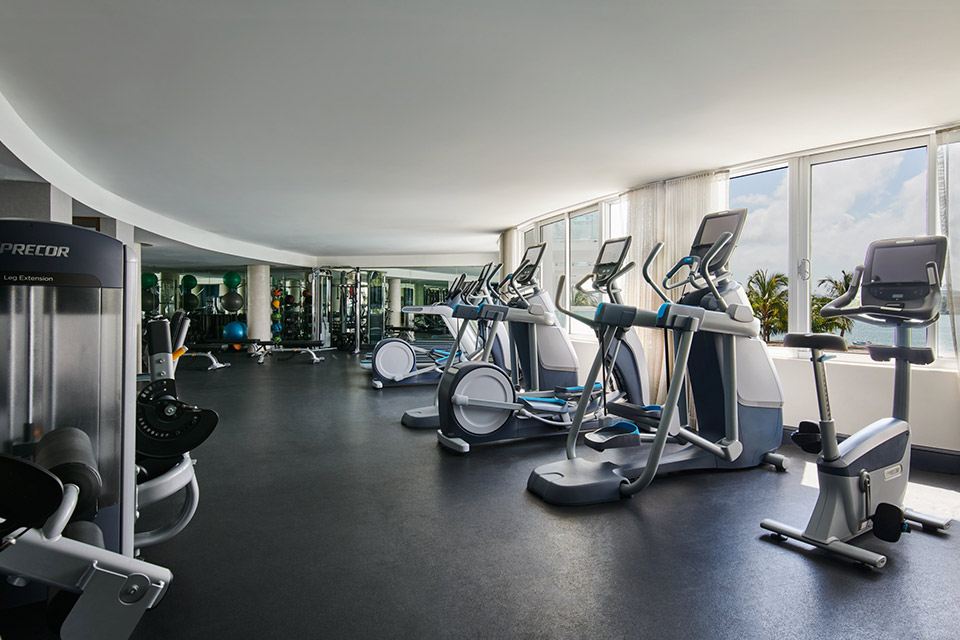 A fitness center with state of the art workout equipment overlooking the ocean.