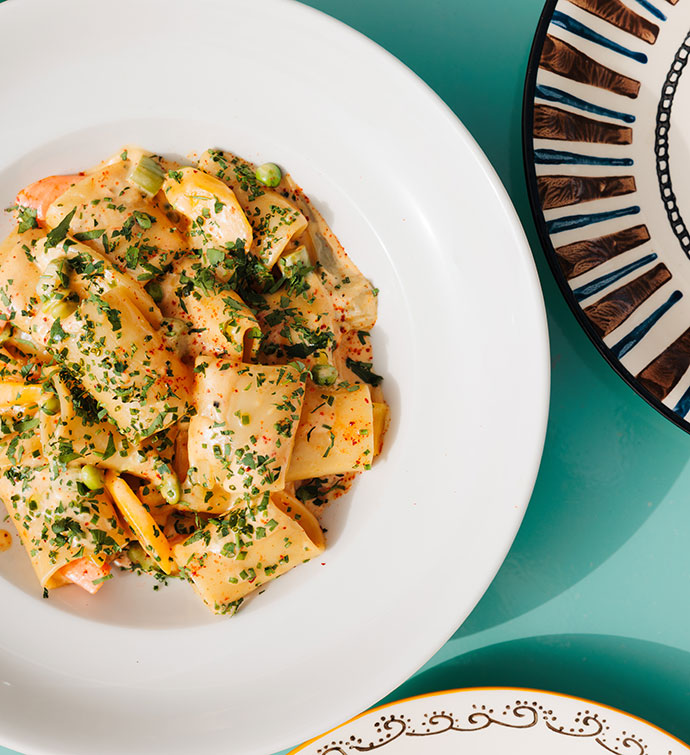 Plate of ravioli pasta in a light cream sauce photographed from above