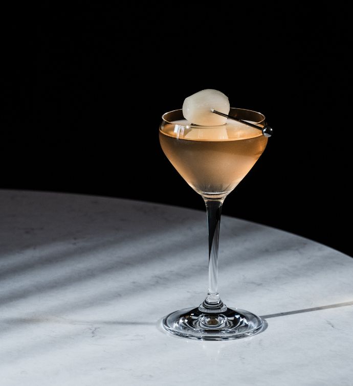 Peach colored cocktail with garnish in a coup glass at Avoca Hong Kong