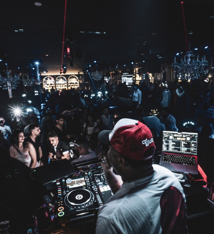 DJ in a red and white hat at Black Orchid Doha