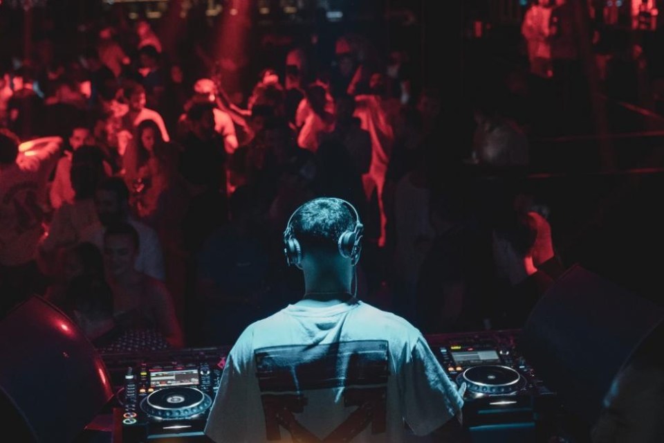 Person DJ-ing in front of a crowd at Black Orchid Doha 