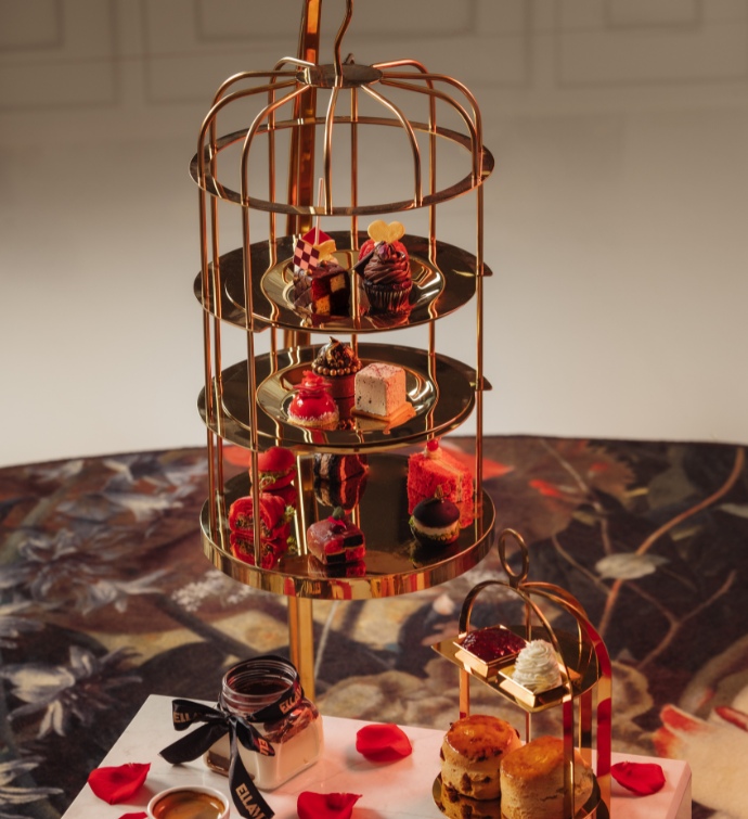 Birdcage filled with desserts at Alice in Wonderland afternoon tea