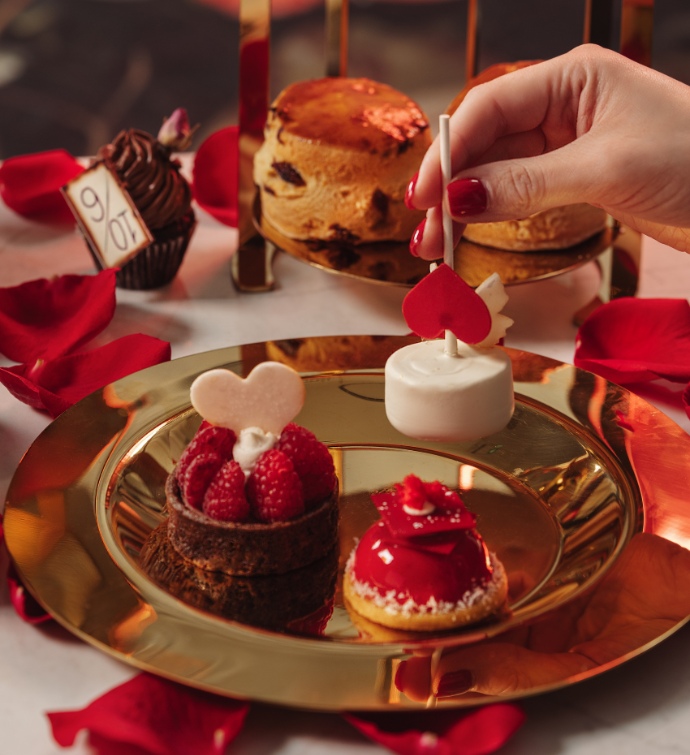 Plate of tarts and desserts at Alice in Wonderland afternoon tea