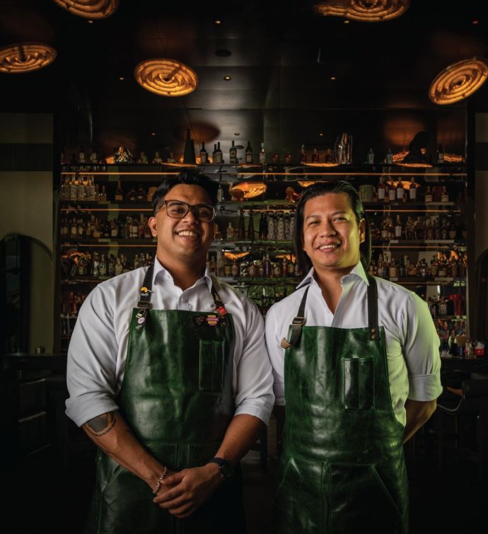 Two bartenders with green aprons at Jungle Ballroom