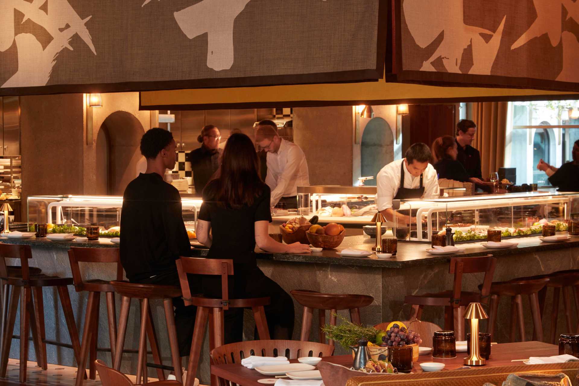 Couple dining at the sushi bar at Morimoto Bordeaux restaurant at Mondrian Bordeaux Les Carmes