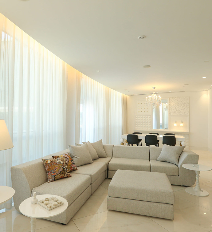 A modern living room featuring a sectional couch and a coffee table.