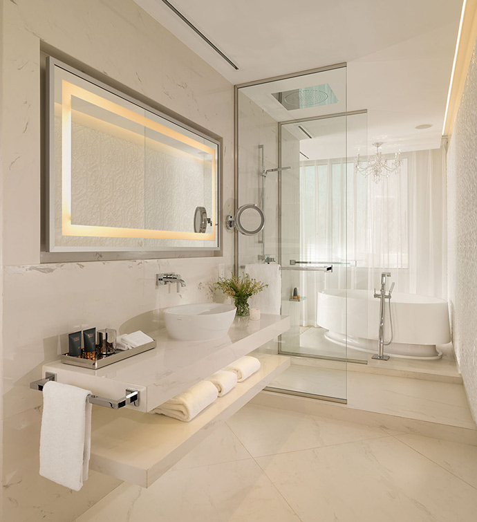 A bathroom with a spacious mirror and a sink.