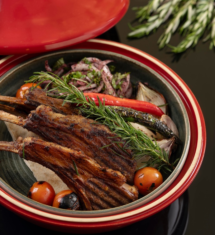 Meat and vegetable dish in a red pot