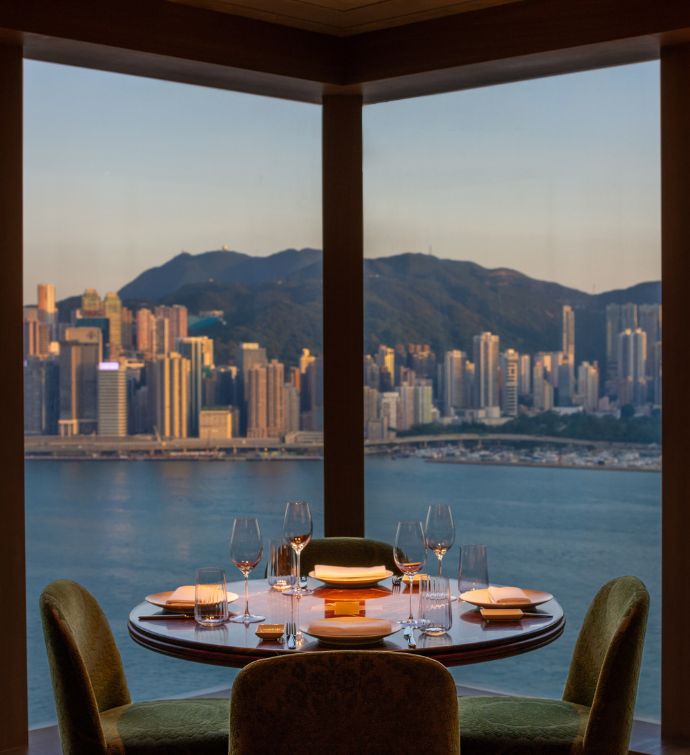 Corner dining area of Carna Hong Kong with views of the harbor