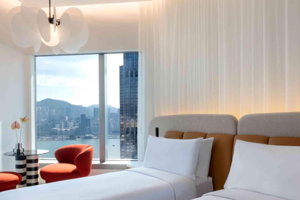 Twin beds in a modern hotel room with water views