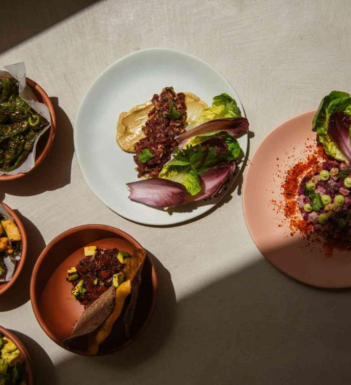 a collection of appetizers plated on colorful plates