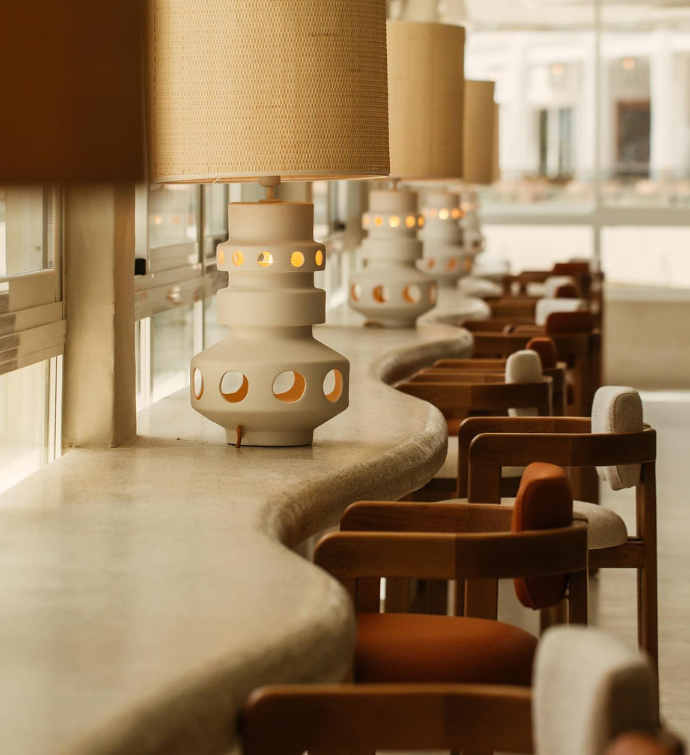 a dining area with modern tables and designed lamps