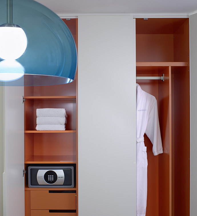 White and orange closet illuminated by a blue light.