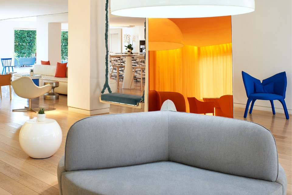 Mondrian Los Angeles lobby with a couch, swing and large mirror