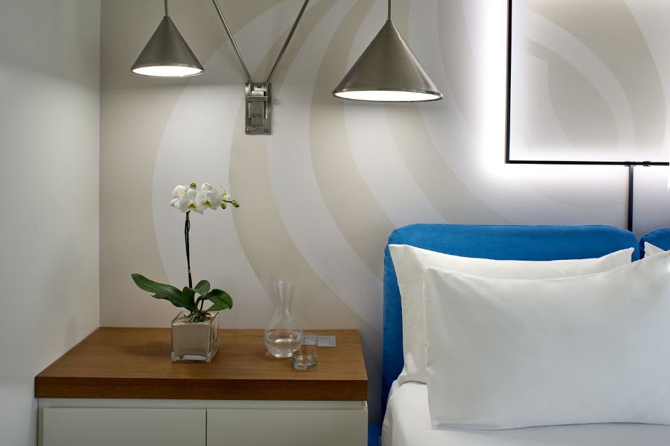 Mondrian Los Angeles guestroom with a blue headboard and wall lighting