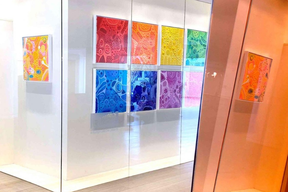 An art gallery with colorful paintings on the wall at Magic Box at Mondrian Los Angeles