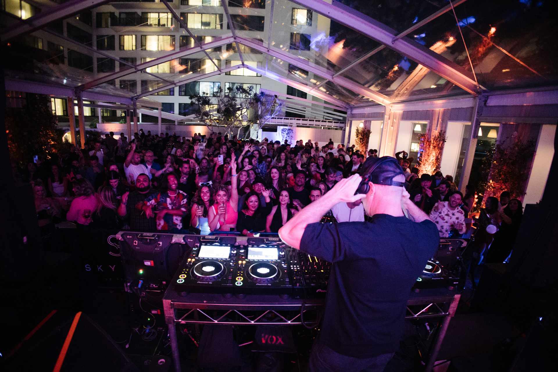 DJ performing in front of a crowd at night at Skybar LA