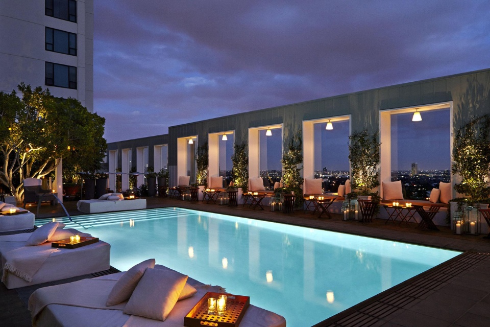 Mondrian LA's Skybar pool at night illuminated with candles