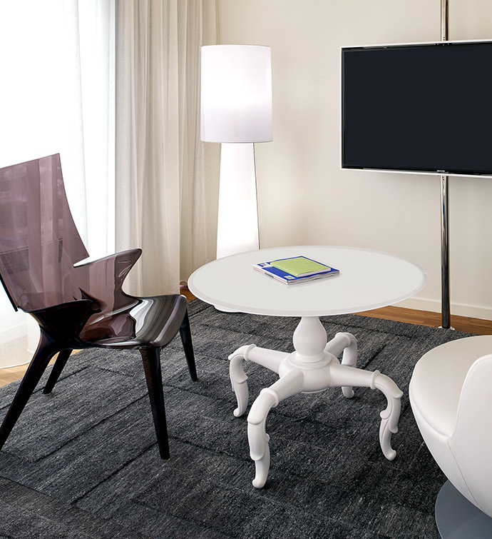 Living room with TV, table, and chair.