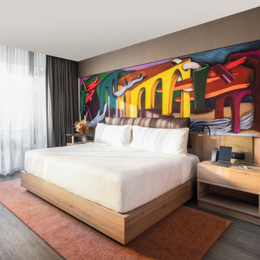 Chambre d'hôtel au Mondrian Mexico City Condesa un lit et une immense fresque murale colorée