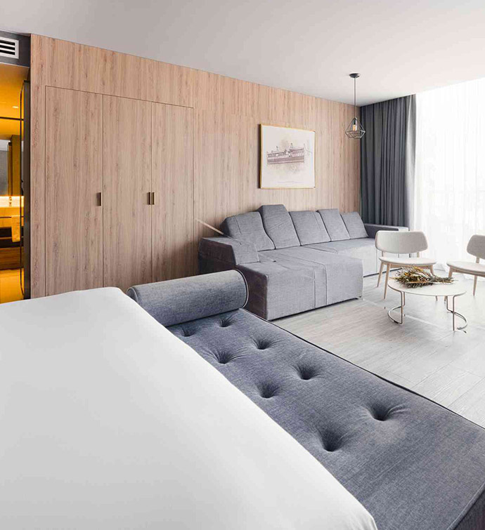 A contemporary hotel room featuring a couch and bed.