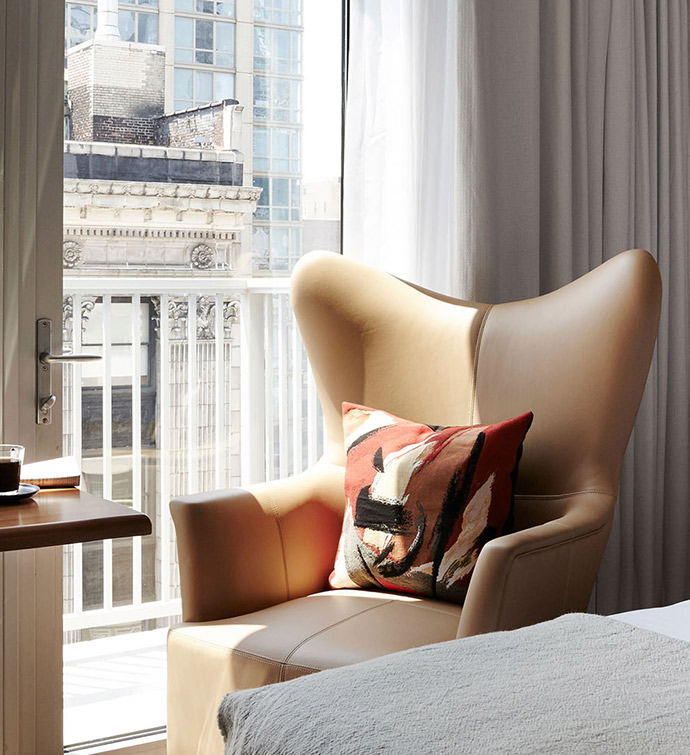 Bedroom with chair, window, and bed.