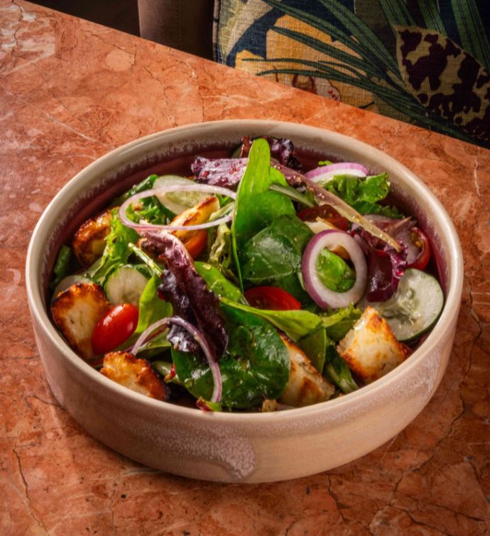 Bowl of salad on a bronze tabletop