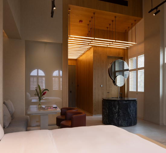 hotel room with high ceiling and a standing dressing area