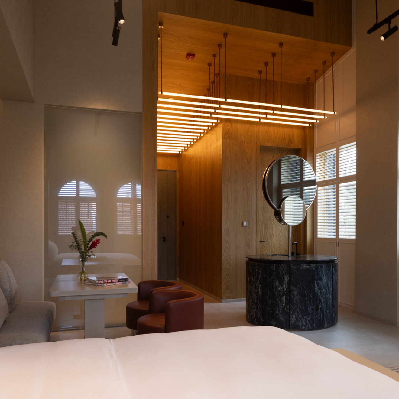 hotel room with high ceiling and a standing dressing area