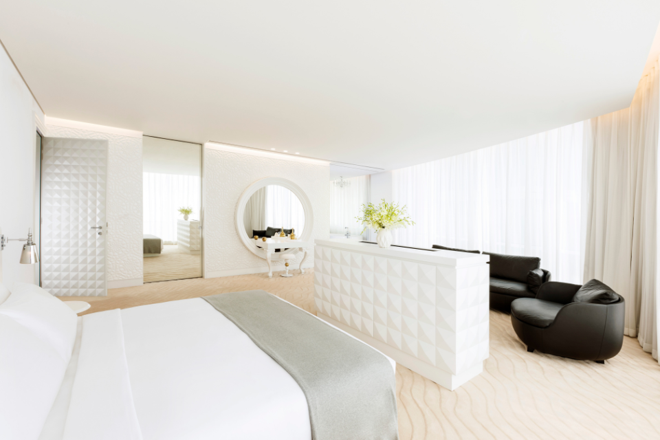 a beautifully decorated two bedroom suite at mondrian doha with white furnishings 