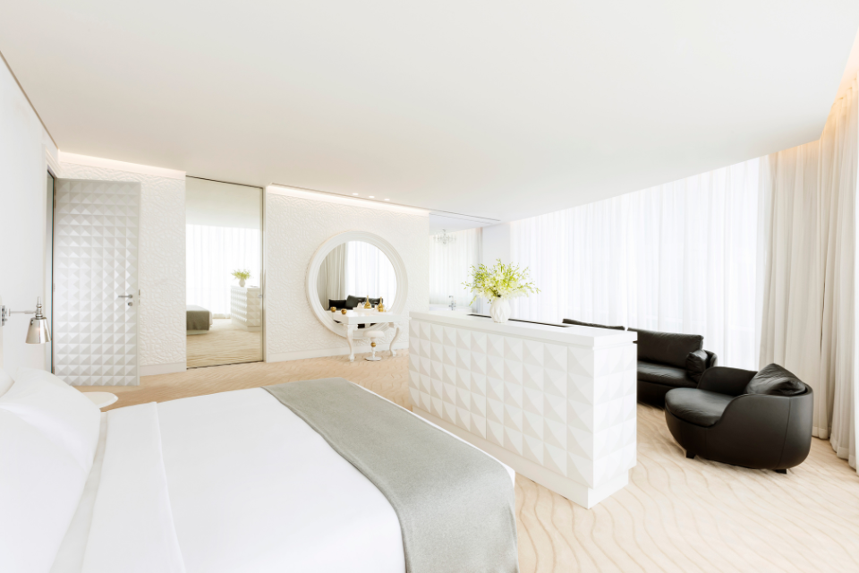 a beautifully decorated two bedroom suite at mondrian doha with white furnishings