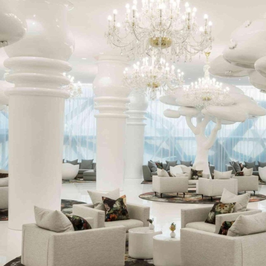 Ellamia doha with couches, oversized white pillars and chandeliers