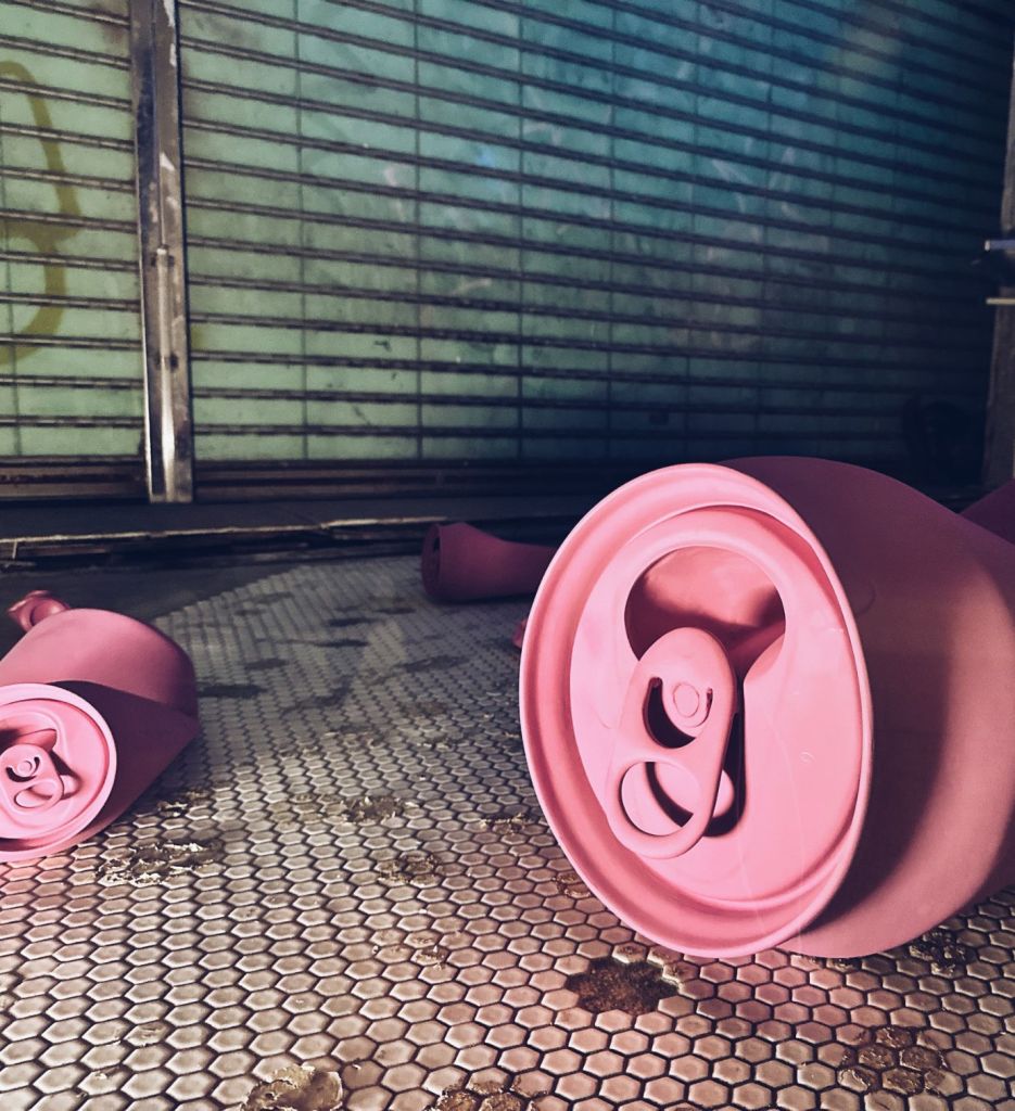 Two oversized pink cans, part of the Crushed Cans installation by Caroline Tronel