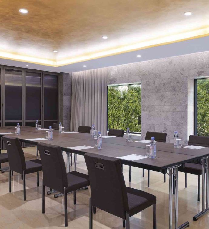 Boardroom with one large dark rectangular table and chairs surrounding it