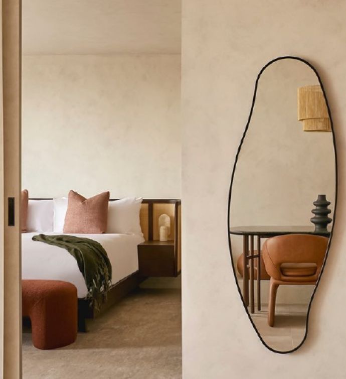 Mirror and bed in background