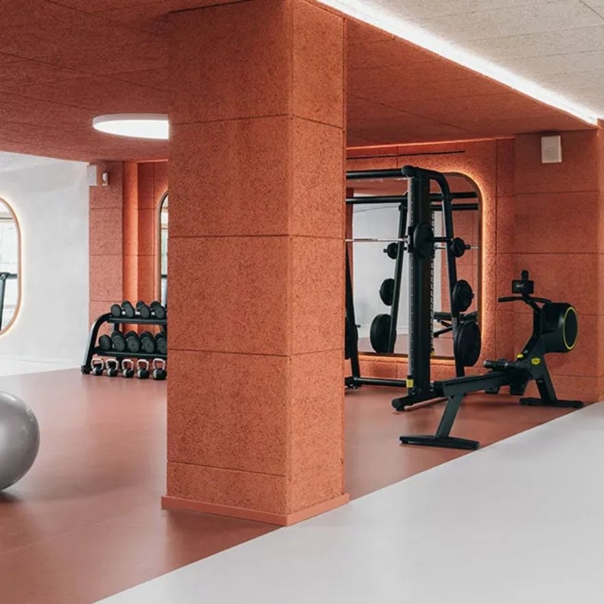 Gym with fitness equipment and orange walls