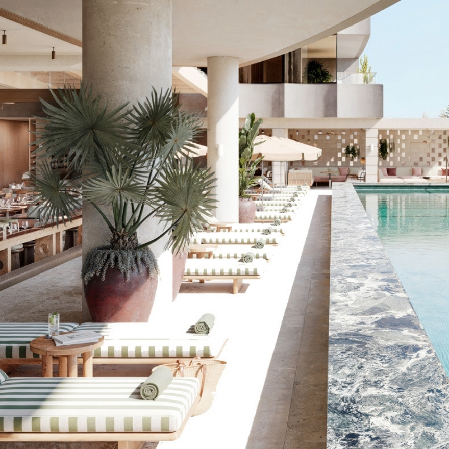 Pool with striped chaise lounge chairs
